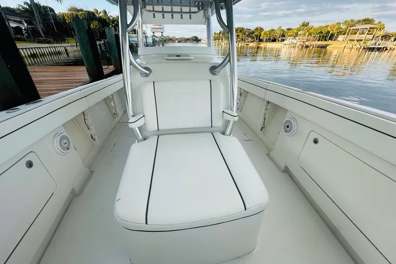 Slide: The Image of 2015 Jupiter 38 FS boat interior with white seating, dockside view. - 22