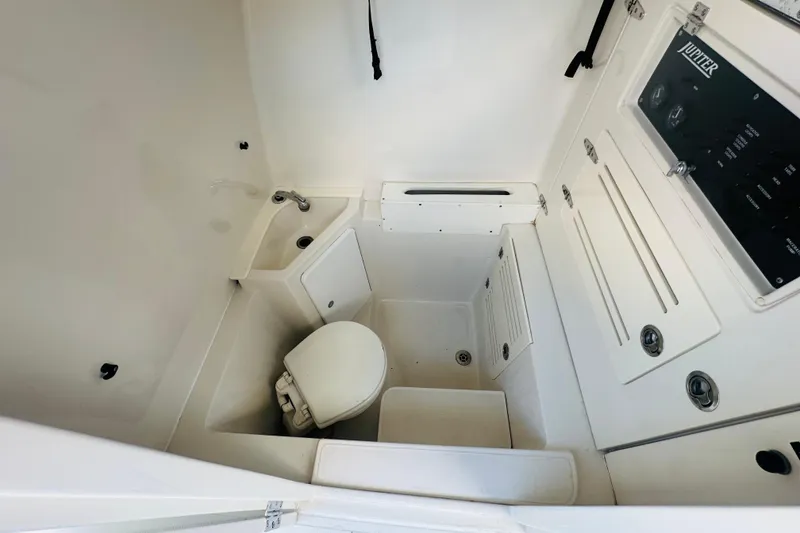 Slide: The Image of 2015 Jupiter 38 FS boat interior with compact bathroom and control panel. - 24