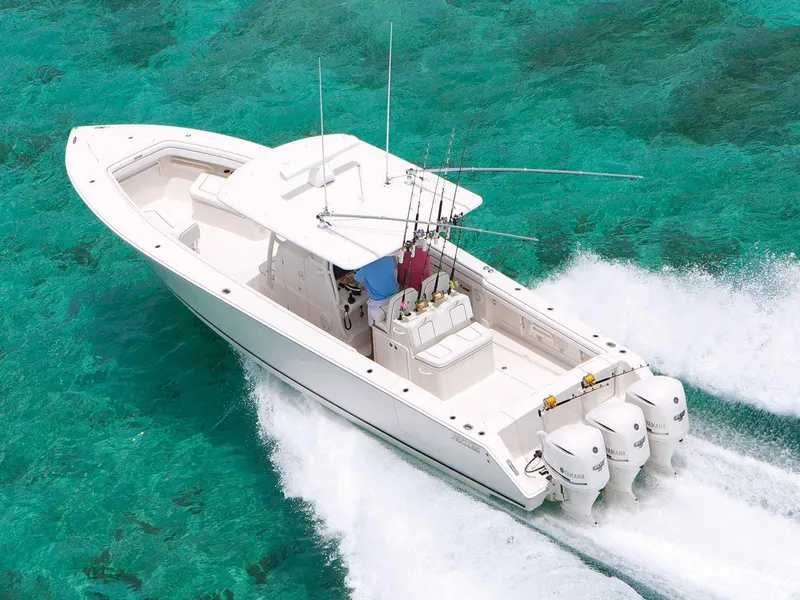 Slide: The Image of 2015 Jupiter 38 FS boat on water near a dock and waterfront home. - 3