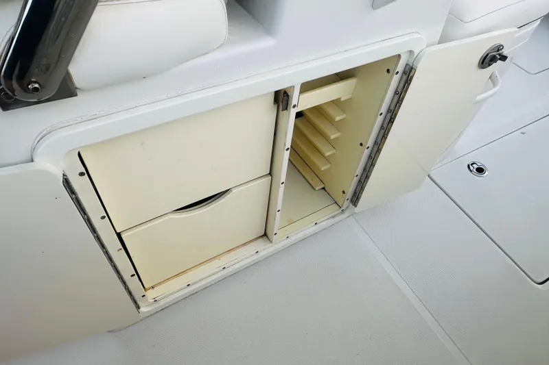 Slide: The Image of 2015 Jupiter 38 FS boat storage compartment with open drawers and shelves. - 31