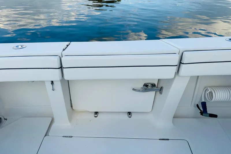 Slide: The Image of 2015 Jupiter 38 FS boat deck with storage compartment and water reflection. - 33