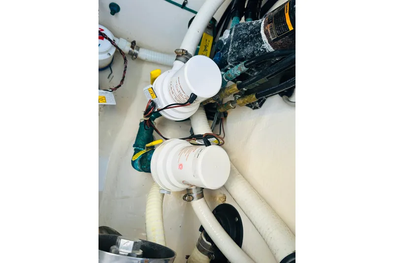 Slide: The Image of Engine compartment of 2015 Jupiter 38 FS boat with visible filters and wiring. - 35