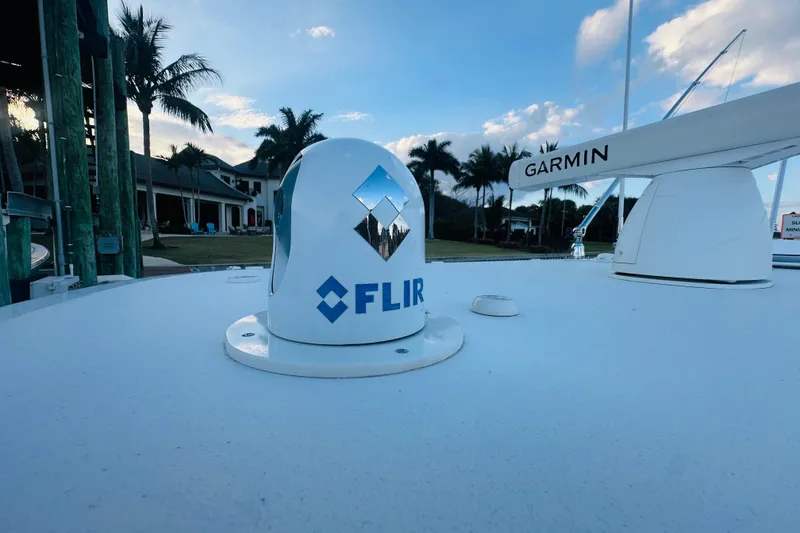 Slide: The Image of FLIR and Garmin equipment on 2015 Jupiter 38 FS boat under blue sky. - 43