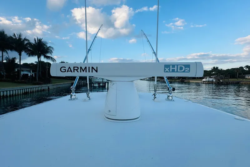 Slide: The Image of Garmin xHD2 radar on 2015 Jupiter 38 FS boat, docked by palm trees and waterway. - 44