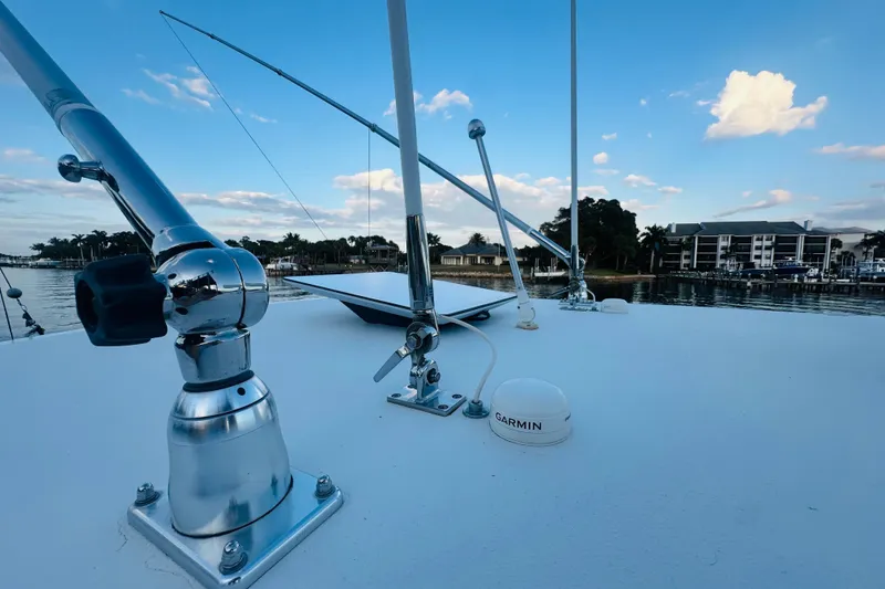 Slide: The Image of 2015 Jupiter 38 FS boat deck with fishing rods and Garmin equipment, dockside view. - 46