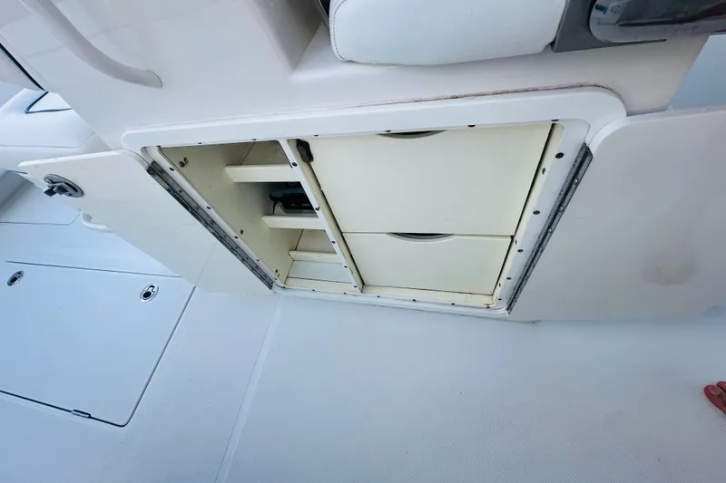 Slide: The Image of Open storage compartment on a 2015 Jupiter 38 FS boat, showcasing interior shelves. - 47