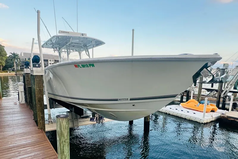 Slide: The Image of 2015 Jupiter 38 FS boat docked on a lift by the water. - 49