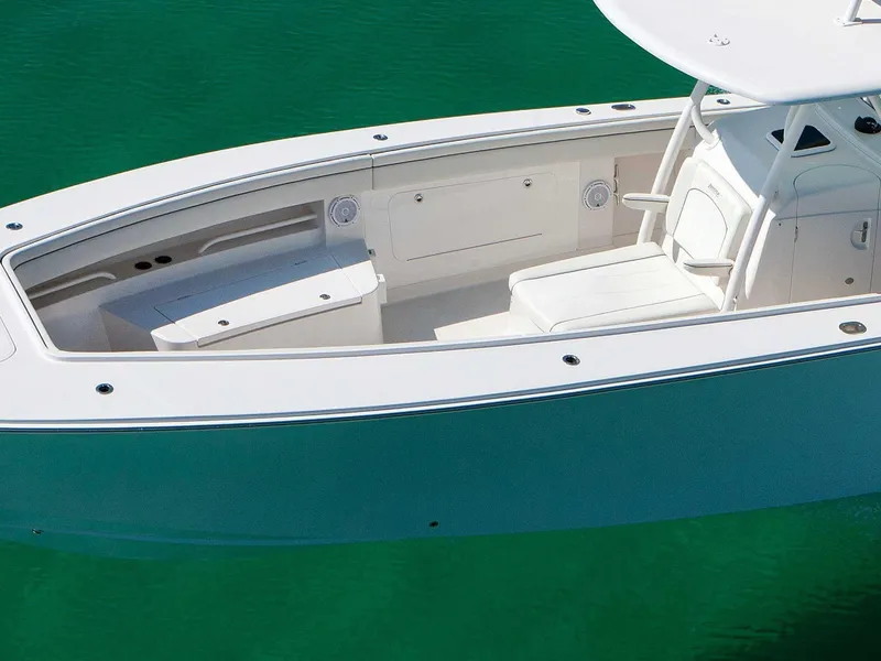 Slide: The Image of 2015 Jupiter 38 FS boat on calm water near a dock, surrounded by palm trees. - 5