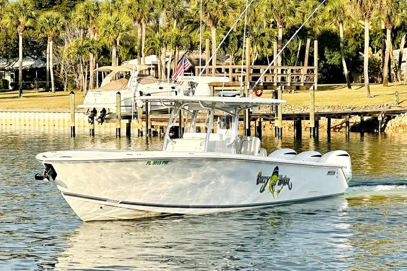 Slide: The Image of 2015 Jupiter 38 FS boat on calm water with palm trees in the background. - 8