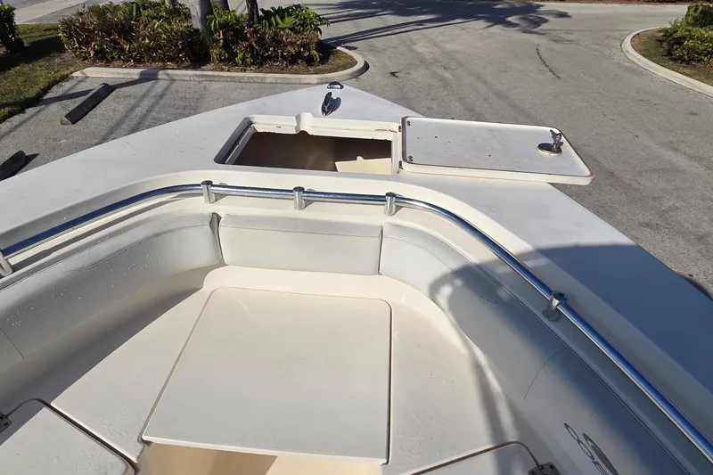 Slide: The Image of 2020 Cobia 237 Center Console boat with open storage compartment and seating area. - 15