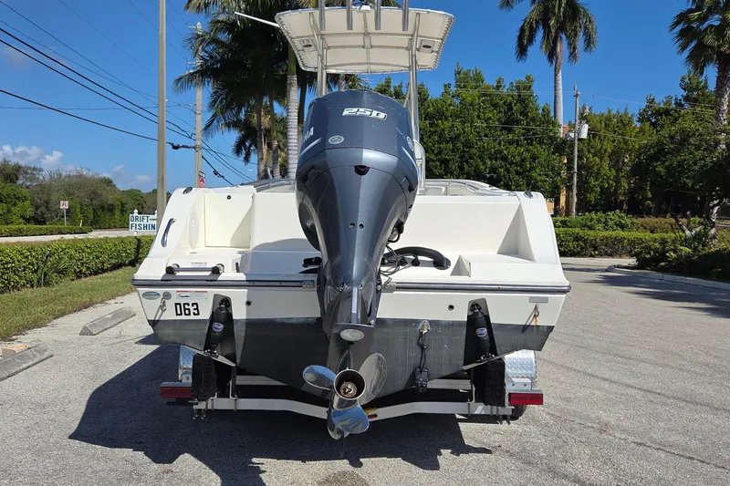 Slide: The Image of 2020 Cobia 237 Center Console boat with Yamaha engine on trailer, parked roadside. - 4