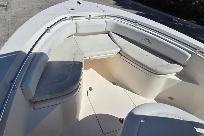 Slide: The Image of 2020 Cobia 237 Center Console boat with spacious seating area and cushioned benches. - 6
