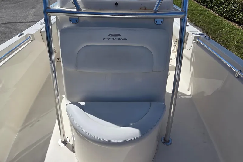 Slide: The Image of 2020 Cobia 237 Center Console boat seating area with stainless steel railings. - 9