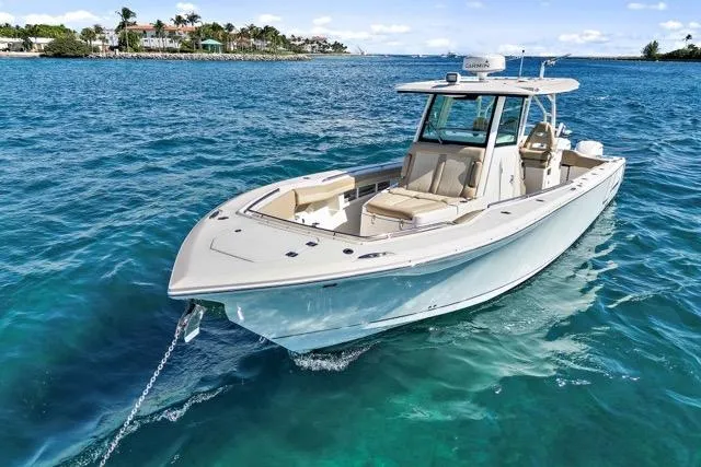 The Image of 2019 Sailfish 360 CC boat on clear blue water, showcasing sleek design and spacious deck. - 1