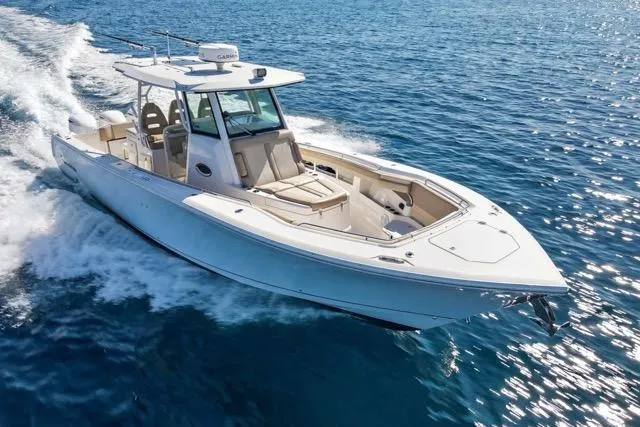 Slide: The Image of 2019 Sailfish 360 CC boat cruising on open blue water. - 10