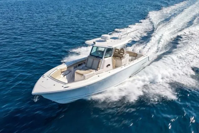 Slide: The Image of 2019 Sailfish 360 CC boat cruising on open blue water. - 11