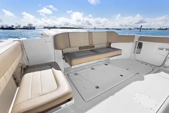 Slide: The Image of 2019 Sailfish 360 CC boat interior with beige seating, ocean view. - 14