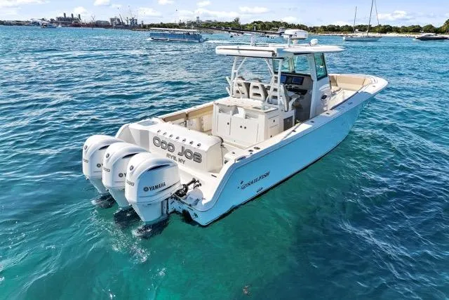 Slide: The Image of 2019 Sailfish 360 CC boat with triple Yamaha engines on clear blue water. - 2