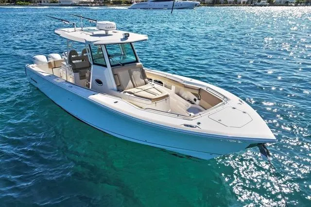 Slide: The Image of 2019 Sailfish 360 CC boat on clear blue water, showcasing sleek design and spacious deck. - 6