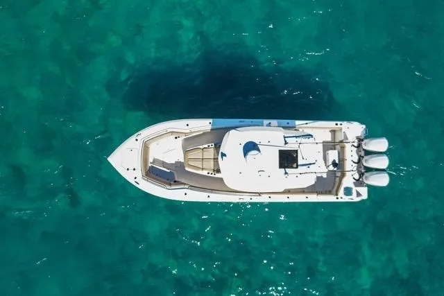 Slide: The Image of Aerial view of 2019 Sailfish 360 CC boat on clear turquoise water. - 9