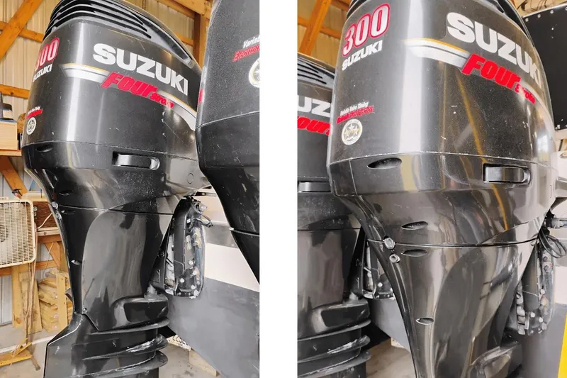 Slide: The Image of Twin Suzuki 300 outboard engines on a 2009 McKee Craft 28 boat in a wooden shed. - 14