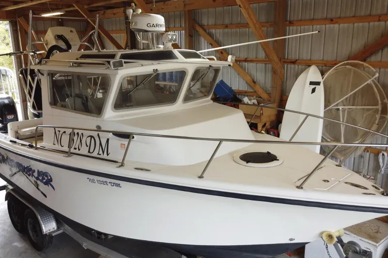 Slide: The Image of 2009 McKee Craft 28 boat in storage, featuring Garmin equipment and visible registration number. - 3