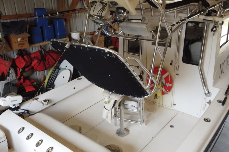 Slide: The Image of 2009 McKee Craft 28 boat interior with fishing gear and safety equipment in storage. - 4