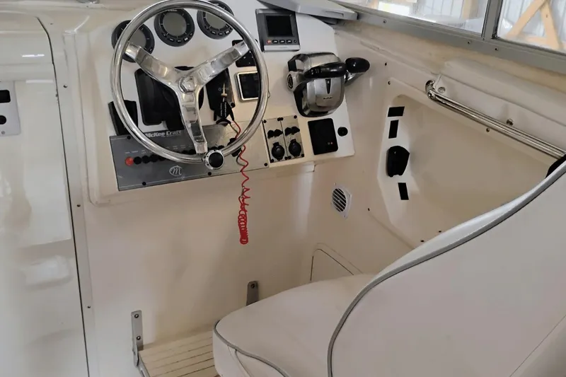 Slide: The Image of 2009 McKee Craft 28 boat cockpit with steering wheel and control panel. - 5