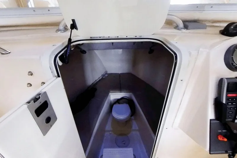 Slide: The Image of 2009 McKee Craft 28 boat interior cabin with storage space and equipment. - 8