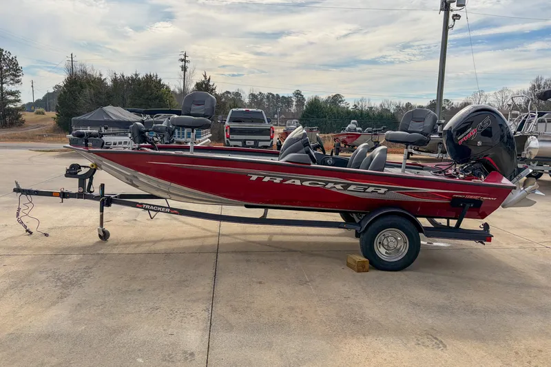 The Image of 2021 Tracker Pro Team 195 TXW boat on trailer, parked outdoors. - 1