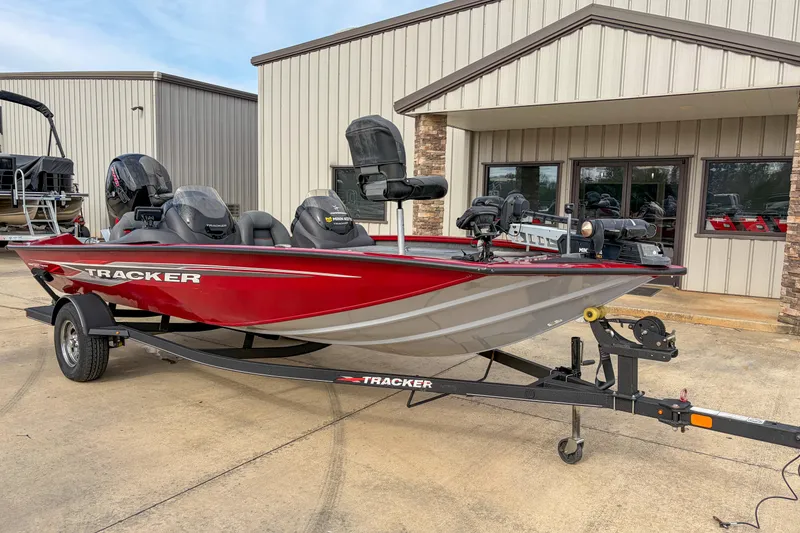 Slide: The Image of 2021 Tracker Pro Team 195 TXW boat on trailer, parked outside a building. - 12