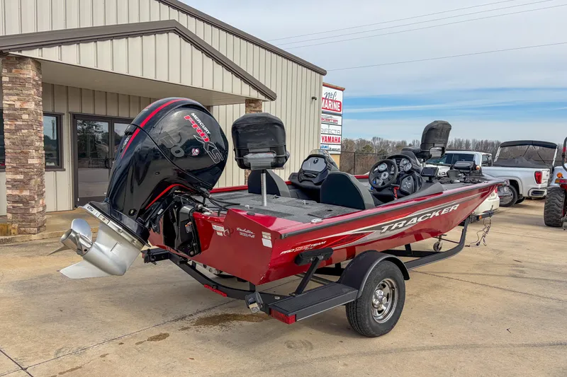 Slide: The Image of 2021 Tracker Pro Team 195 TXW boat with Mercury engine, parked outside a marine dealership. - 4