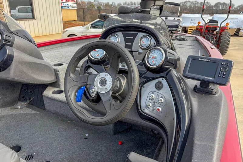 Slide: The Image of 2021 Tracker Pro Team 195 TXW boat dashboard with steering wheel and navigation system. - 7