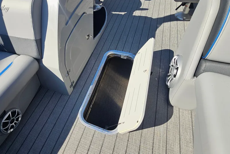 Slide: The Image of 2026 Bentley Pontoons LEGACY 243 QUAD SWINGBACK interior storage compartment open on deck. - 11