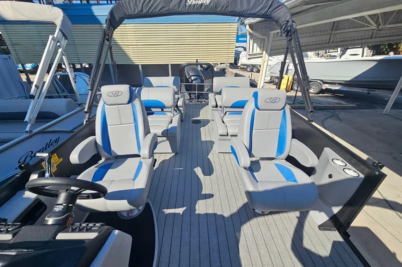 Slide: The Image of 2026 Bentley Pontoons LEGACY 243 QUAD SWINGBACK interior with blue and gray seating. - 12
