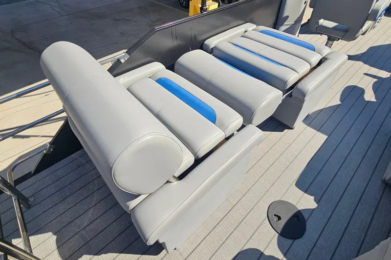 Slide: The Image of 2026 Bentley Pontoons LEGACY 243 QUAD SWINGBACK seats, featuring sleek gray and blue upholstery. - 18