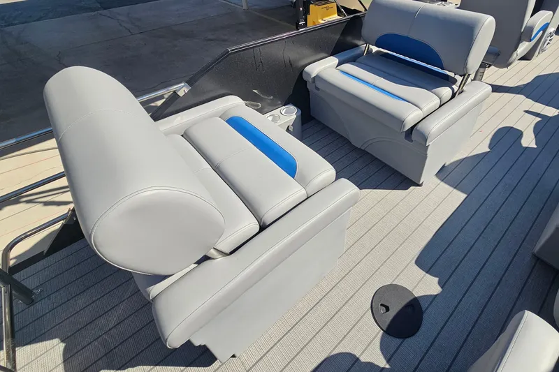 Slide: The Image of 2026 Bentley Pontoons LEGACY 243 QUAD SWINGBACK interior with gray and blue seating. - 19