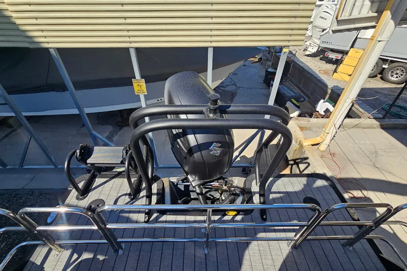 Slide: The Image of 2026 Bentley Pontoons LEGACY 243 QUAD SWINGBACK, rear view with motor and railing. - 22