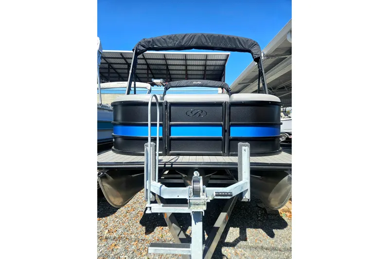Slide: The Image of 2026 Bentley Pontoons LEGACY 243 QUAD SWINGBACK on trailer, featuring sleek black and blue design. - 3