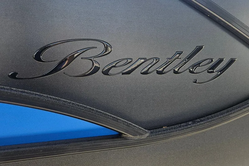 Slide: The Image of 2026 Bentley Pontoons LEGACY 243 QUAD SWINGBACK logo on sleek black surface. - 6