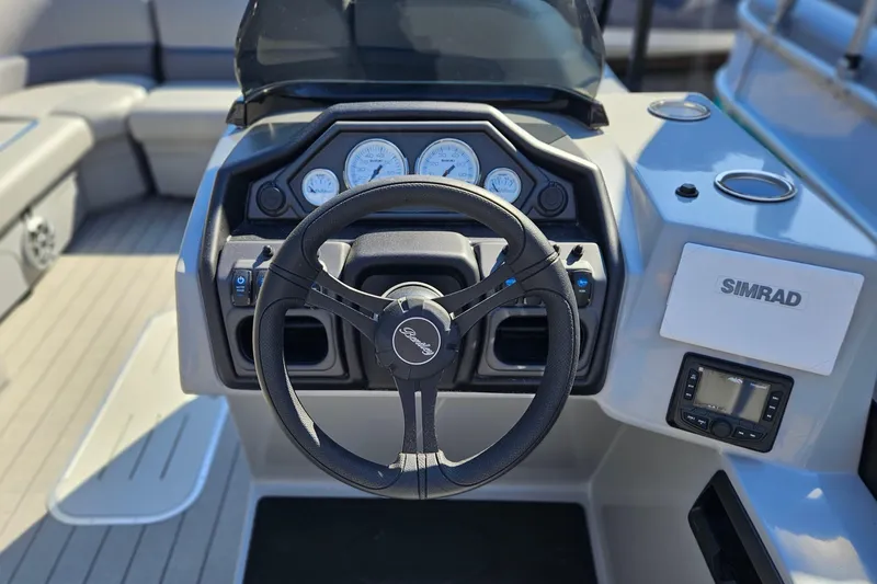 Slide: The Image of 2026 Bentley Pontoons LEGACY 243 QUAD SWINGBACK dashboard with steering wheel and Simrad display. - 9