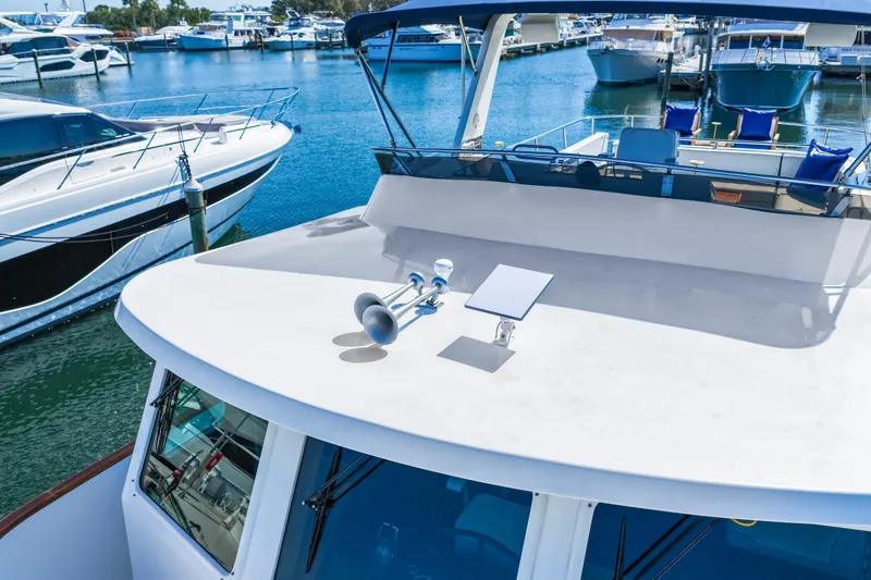 Slide: The Image of 2008 DeFever 52 Euro yacht docked at marina, surrounded by other boats. - 11