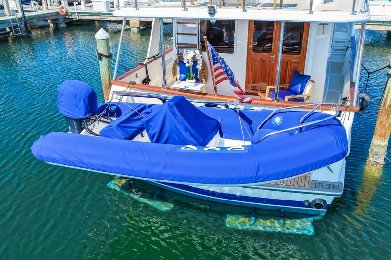 Slide: The Image of 2008 DeFever 52 Euro yacht with blue covers, docked in a marina. - 14