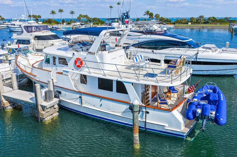 Slide: The Image of 2008 DeFever 52 Euro yacht docked in a marina with blue inflatable boat. - 15