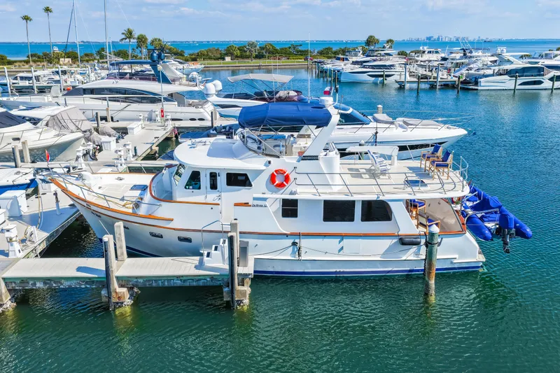 Slide: The Image of 2008 DeFever 52 Euro yacht docked in a marina with other boats. - 16