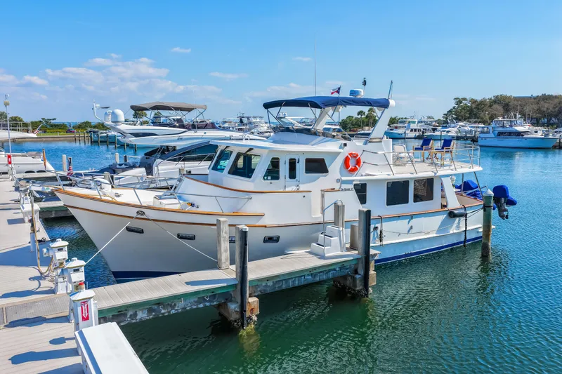 Slide: The Image of 2008 DeFever 52 Euro yacht docked at marina under clear blue sky. - 2