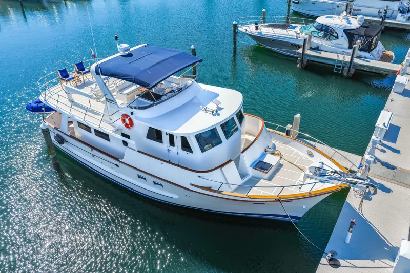 Slide: The Image of 2008 DeFever 52 Euro yacht docked in marina, featuring spacious deck and elegant design. - 20