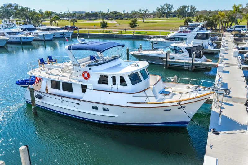 Slide: The Image of 2008 DeFever 52 Euro yacht docked in a marina with clear blue water. - 21