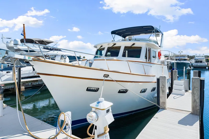 Slide: The Image of 2008 DeFever 52 Euro yacht docked at marina under blue sky. - 22