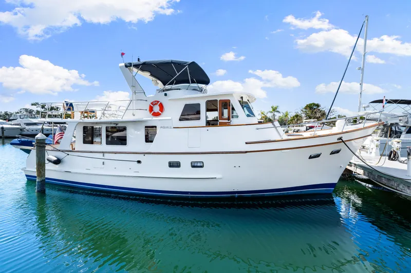 Slide: The Image of 2008 DeFever 52 Euro yacht docked in a marina under a clear blue sky. - 23